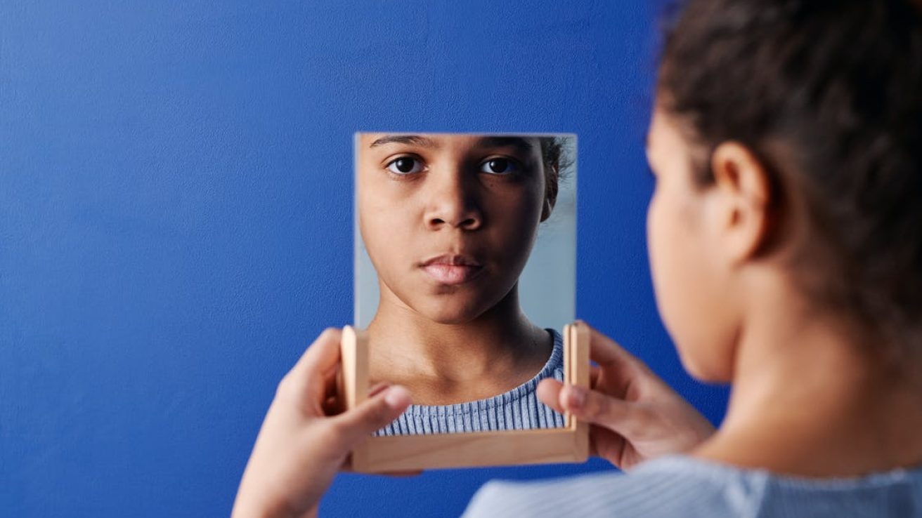 child looking in mirror