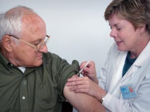 a geriatric patient receiving a vaccination from a healthcare provider