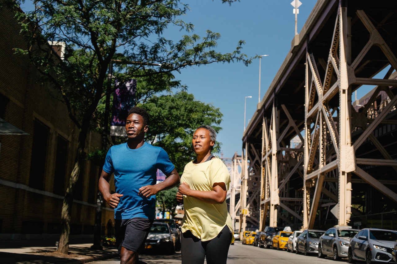 A mother and son running next to a bridge in NY