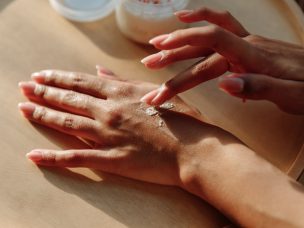 a person putting eczema cream on their hands