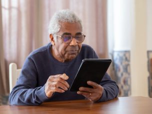 an elderly black man reading a book
